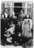 Line up may be:  Standing l-r: Harry, Harriet (mother), George (father - added c. 3 yrs after death), Maggie (eldest girl - c. 14), Rose;  Sitting center: Hettie, Jack ; Sitting front: Winifred, Fred (c. 3)